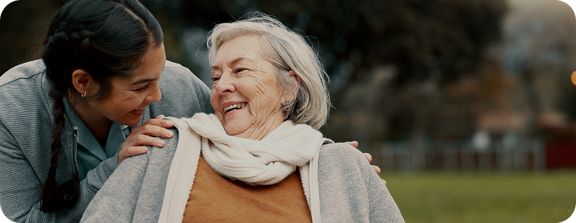 A girl looking at her mother and they both are smiling