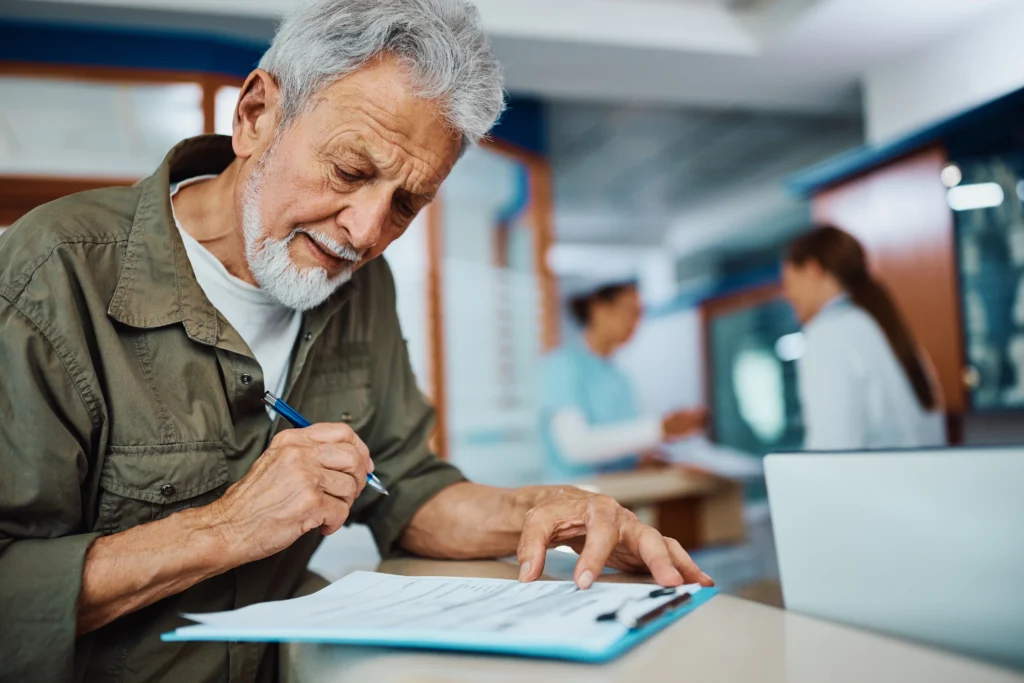 man filling out medical paperwork