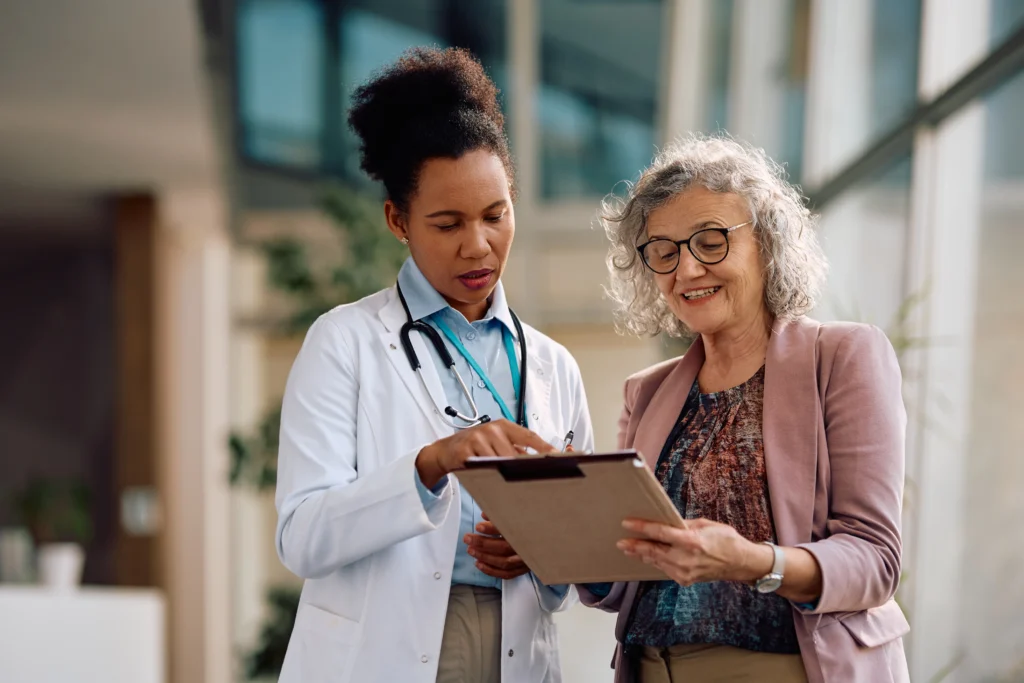 A medicare agent talking to a adult about Common Mistakes To Avoid during their annual wellness exam visit.