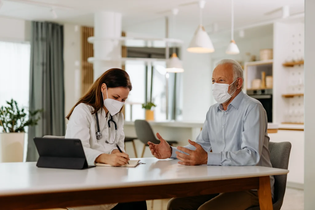 A doctor reviewing medical history of a patient at his home.