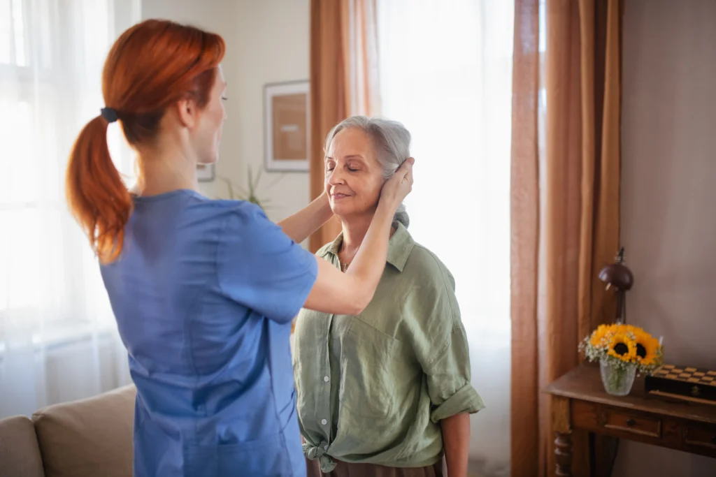A nurse providing Physical Therapy to a old lady at home that covers under Medicare Home Health Services.
